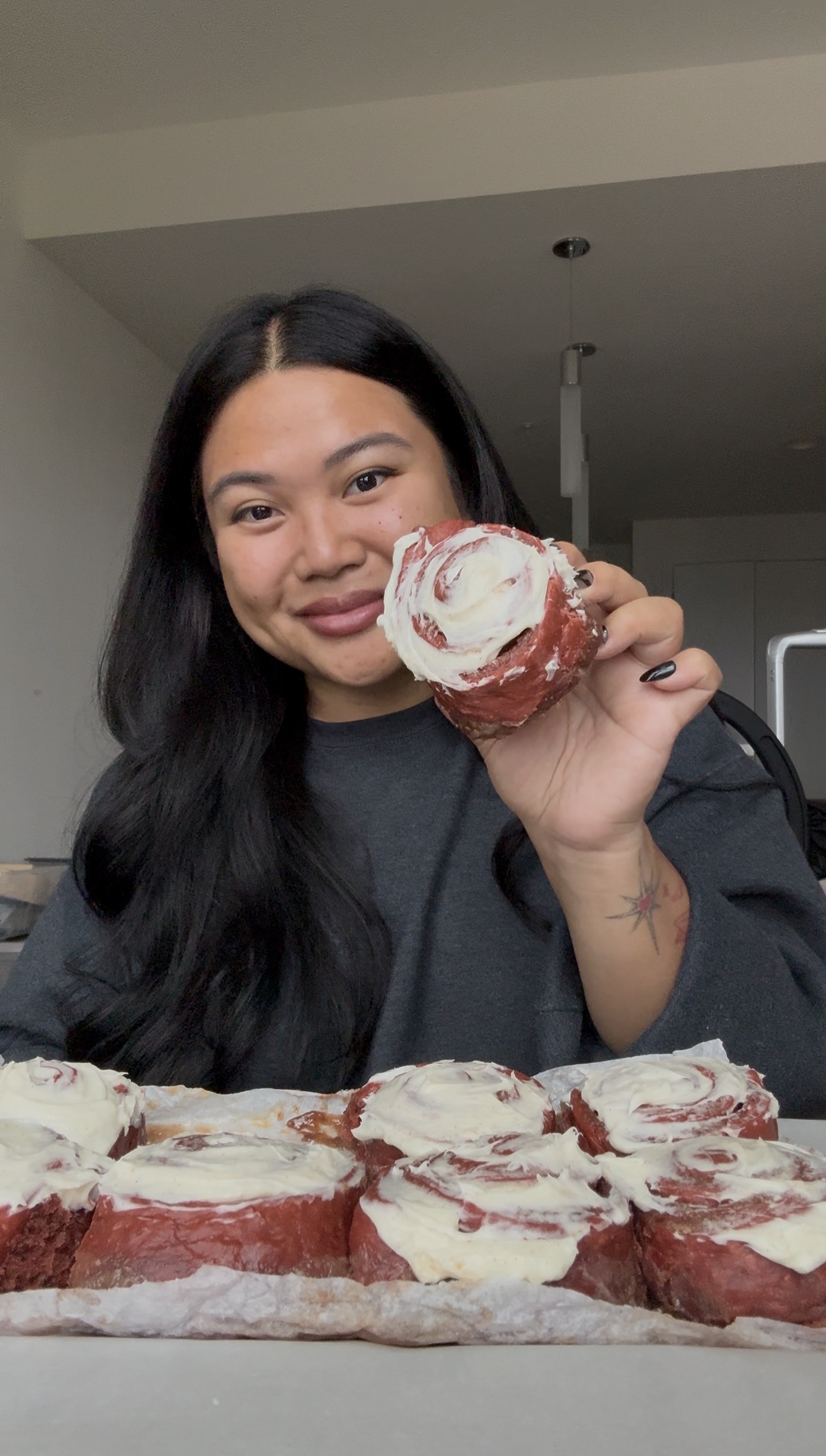 Holding red velvet cinnamon rolls